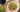 Porridge with kiwi and nuts on top with prunes to side