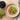 Porridge with kiwi and nuts on top with prunes to side